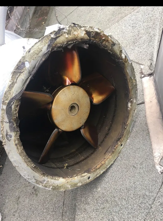 Extractor fan with brown grease on the blades and hub